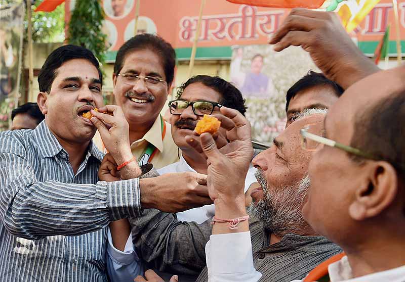 BJP supporters distribute sweets as they celebrate party's victory in Jammu & Kashmir and Jharkhand Assembly polls, in Mumbai. (PTI)
