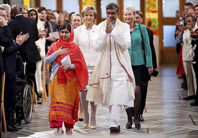 Nobel Peace Prize winners Malala Yousafzai from Pakistan, center left, and Kailash Satyarthi of India arrive for the Nobel Peace Prize award ceremony in Oslo, Norway, Wednesday, Dec. 10, 2014. The Nobel Peace Prize is being shared between Malala Yousafzai, the 17-year-old Taliban attack survivor, and the youngest Nobel Prize winner ever, and Indian children's rights activist Kailash Satyarthi in a ceremony in Oslo. (AP/PTI)