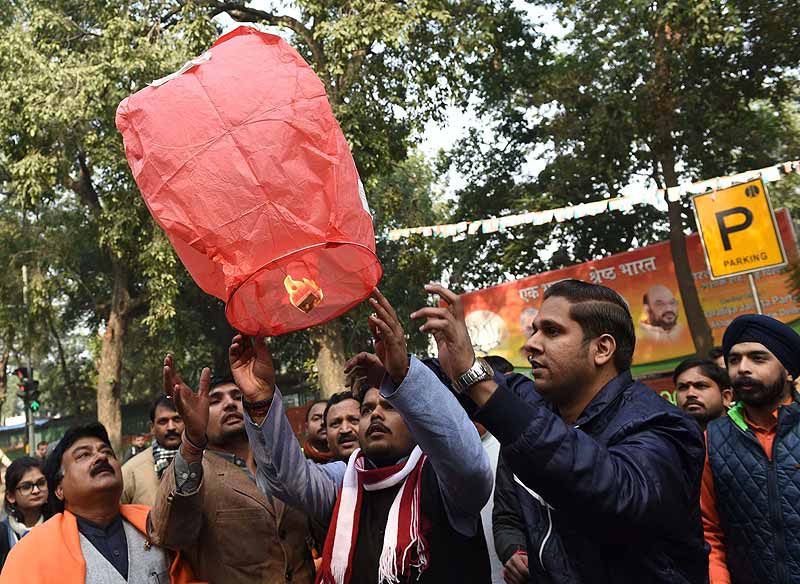 BJP supporters celebrate party's victory in Jammu & Kashmir and Jharkhand Assembly polls, at BJP headquarters in New Delhi on Tuesday. (PTI)
