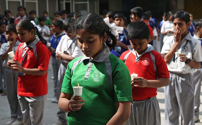 School students offer prayers for victims killed in a Taliban attack on a military-run school in Peshawar, at a school in Hyderabad. (AP)
