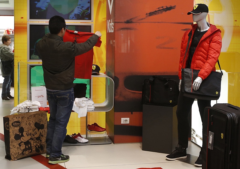 A man looks a shirt in a Ferrari Store. (AP)