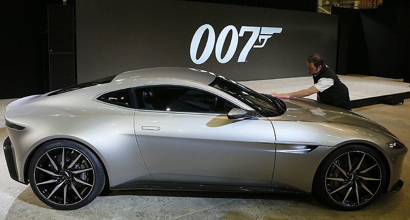 A worker polishes an Aston Martin DB10 car during an event to mark the start of production for the new James Bond film. (Reuters)