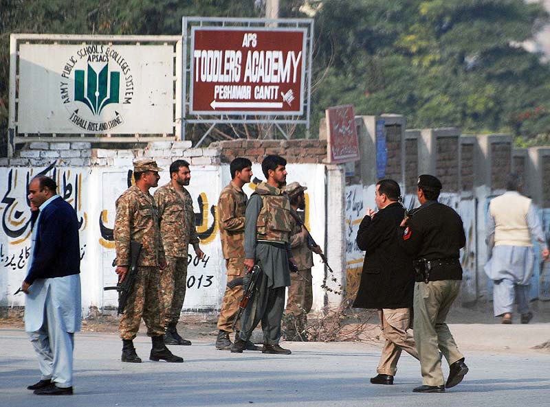 Pakistani security forces takes up a positions on a road leading to the Army School that is under attack by Taliban gunmen in Peshawar. Reuters