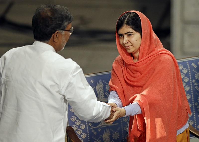 Nobel Peace Prize winners Malala Yousafzai from Pakistan and Kailash Satyarthi of India shake hands during the Nobel Peace Prize award ceremony. (AP)
