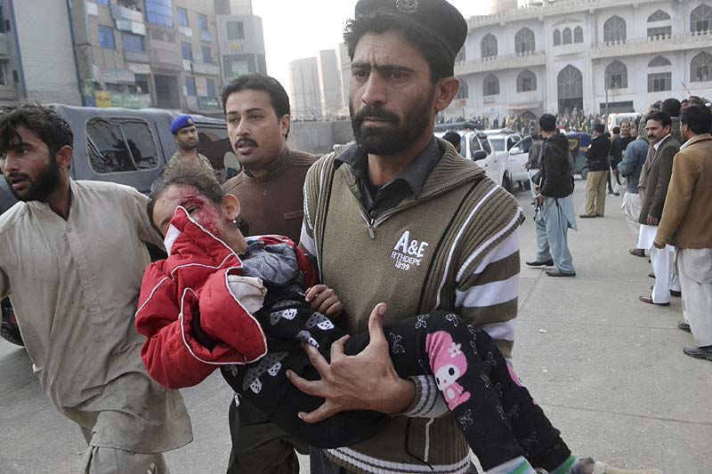 A girl, who was injured in Taliban attack, is rushed to a hospital in Peshawar, Pakistan. AP