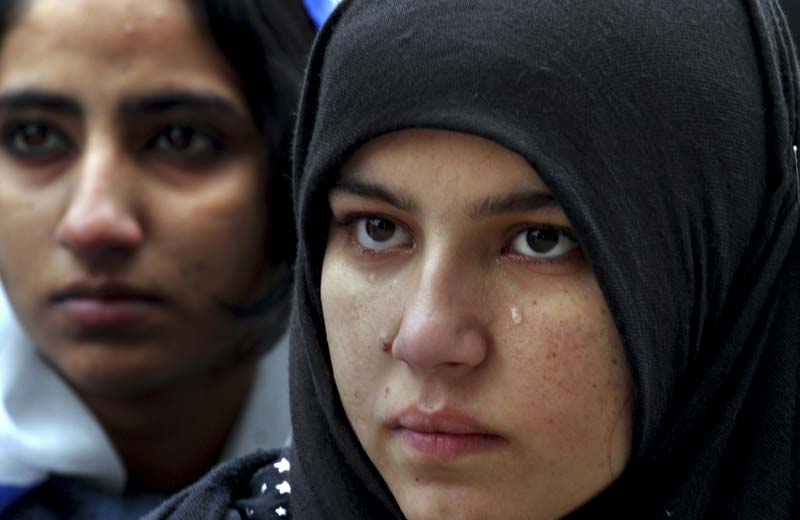 A Pakistani student weeps as she attends a special ceremony for the victims of Peshawar school attack, in Lahore. AP