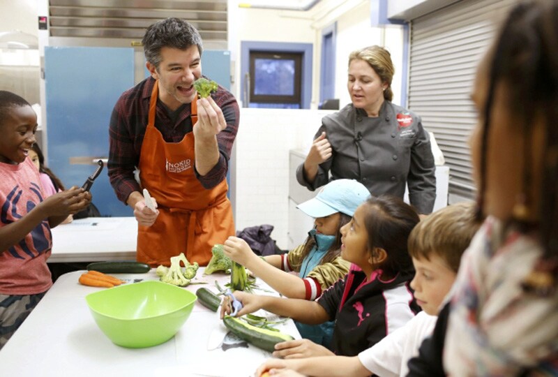 Uber Chief Executive Officer (CEO) Travis Kalanick (2nd L) works with chef Amy Kien, of Revolution Food, to help with Cooking Matters, a nutrition class taught by 18 Reasons, a local partner of Share our Strength at Glen Park Elementary School in San Francisco, California.