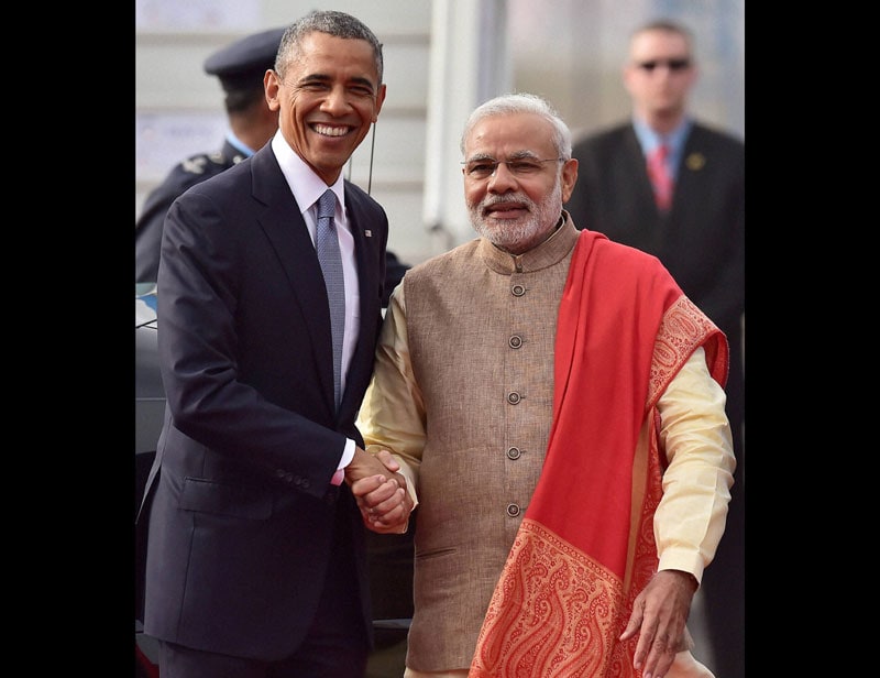 Prime Minister Narendra Modi shakes hands with US President Barack Obama upon his arrival at Air Force station Palam, in New Delhi on Sunday. (PTI)