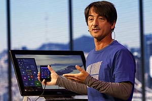 Joe Belfiore, vice president for the operating systems group at Microsoft, works with a mobile phone and desktop computer at Microsoft Build in San Francisco, California April 29, 2015. REUTERS