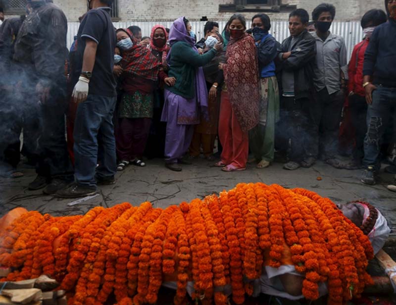 Relatives mourn next to the body of their relative, who died in Saturday's earthquake, during a cremation along a river in Kathmandu, Nepal April 28, 2015. (Reuters)