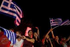 Supporters of the No vote wave Greek flags and shout slogans as they celebrate after the results of the referendum in Synatagma square in central Athens, on Sunday, July 5, 2015. (Photo: AP)