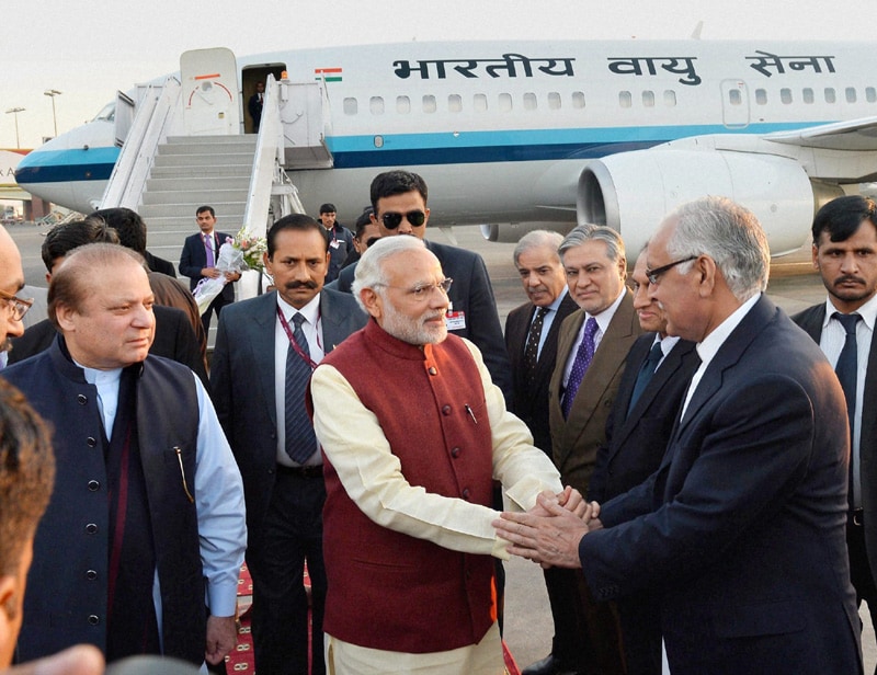 2. Narendra Modi Pakistan visit: Nawaz Sharif received Narendra Modi and the two shared a warm embrace after the Indian leader emerged from his special aircraft at Allama Iqbal International Airport. Modi, who was attired in off white kurta, white pyjama and red waistcoat, extended birthday greetings to Sharif, who wore light blue shalwar kameez and dark blue waistcoat. He was also presented a bouquet by Sharif. (PTI photo)