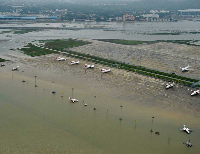 Chennai Floods: The reduction in water levels of Adyar and Kumbh rivers are likely to ease the situation in the city where flood waters are also likely to recede. <br>Image Caption: A view of Chennai Airport flooded due to heavy rains, on Thursday. (PTI)</br>