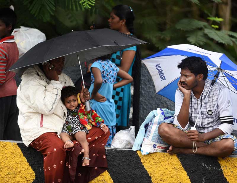 Chennai Floods: While intermittent rains have been forecast for Chennai, coastal and interior Tamil Nadu will receive more rains in the next 24 hours. The Grand Southern Trunk Road that links Chennai with Madurai and beyond was cut off after breaches in several places in Kanchipuram district. <br>People rescued from waterlogged houses of Kotturpuram, sitting at a road in Chennai (PTI)</br>