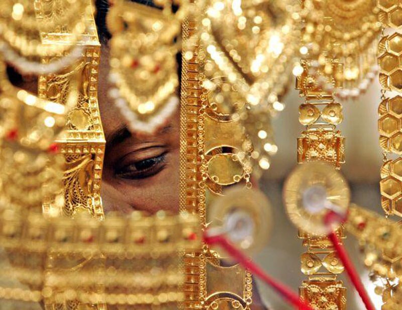 Gold: Gold prices continued to slide as prices of the yellow metal fell in the international market following expectation of interest rate hike by US Federal Reserve.The domestic demand was down as people waited for correction in prices. (AP photo) <br><a href="https://www.financialexpress.com/topic/year-ender-2015/"><strong>Full coverage: Year-Ender 2015</strong></a></br>