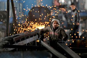 In this Thursday, Feb. 25, 2016 photo, a worker from India arranges steel tubes at a factory in the Muwaqer Industrial Estate, in northern Jordan. A new trade deal with Europe, a rush of foreign investment and ambitious public works are to put 200,000 Syrian refugees to work in Jordan in what the international community says is a precedent-setting new approach to the biggest displacement crisis in decades. (AP Photo/ Raad Adayleh)