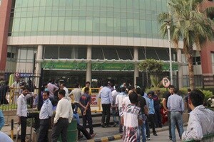 Gurgaon: People come out of offices after an earthquake in Gurgaon on Sunday. PTI Photo (PTI4_10_2016_000276A)