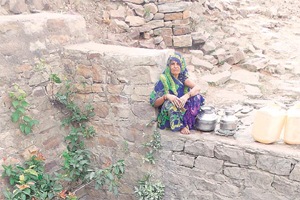 Asharani Yadav of Majhora has spent spent nearly an hour by the village ziriya today to scoop out enough water for her family. (Express photo)