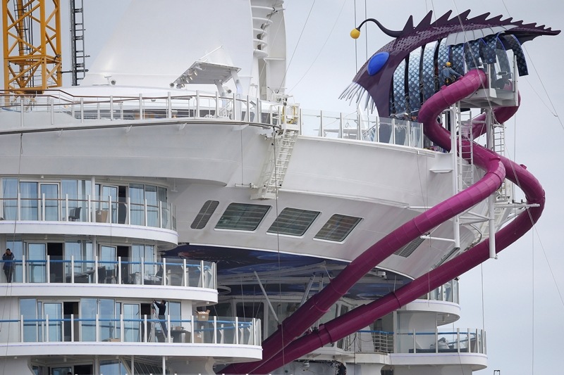 Among the onboard attractions are "The Ultimate Abyss", a 10-storey slide from the top deck to the boardwalk which RRCL bills as the world's biggest ship-mounted slide. The purple slide can be clearly seen at the rear of the ship. (Reuters Photo)