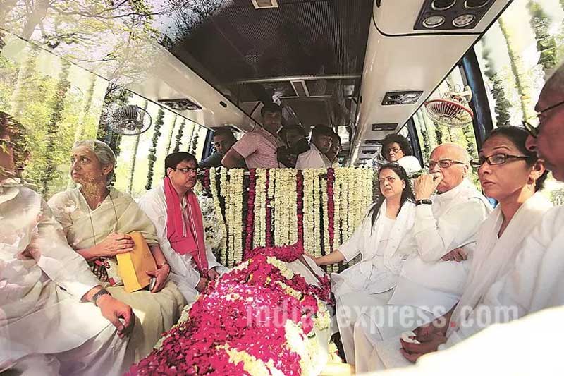 Kamla Advani, the wife of BJP veteran L K Advani, died on April 6 at the All India Institute of Medical Sciences (AIIMS) due to heart failure. BJP senior leader L.K. Advani sit next to her wife Kamla Advani body, leaves his house for Nigambodh ghat cremation ground in New Delhi. (Source: Express photo by Ravi Kanojia)