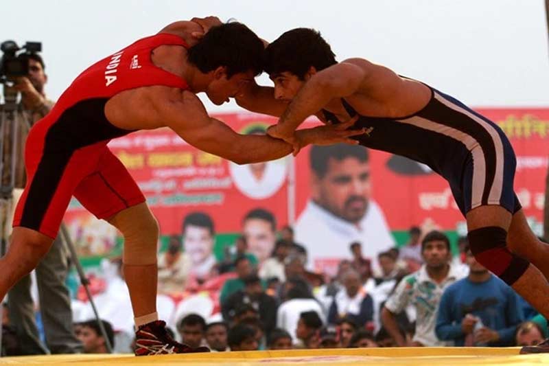 Sandeep Tomar of Services (in Blue} and Nitin of Punjab at the 55kg final during the Senior National Wrestling championshi in, Nandini nagar, Gonda (UP) on Nov 9th 2012. Express photo by RAVI KANOJIA.