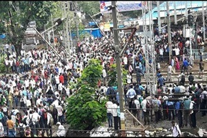 Commuters come on to the tracks in protest against train delay. (ANI photo)