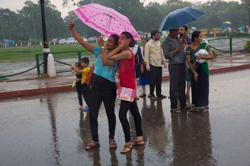 Despite the discomfort and inconvenience, the rain lash was a welcome change.People stepped out to enjoy the first shower of the season. India Gate witnessed crowd pouring in to enjoy themselves and clicking pictures in the breeezy weather. (AP)