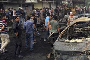 Baghdad : Iraqi security forces and civilians gather at the site after a car bomb at a commercial area in Karada neighborhood, Baghdad. (AP/PTI)