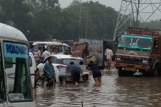 Gurgaon and Bengaluru rains: Heavy downpour has caused huge traffic jams in these two major business hubs of the country and in several other parts, causing major damage to cars in several instances. (Photo: PTI)