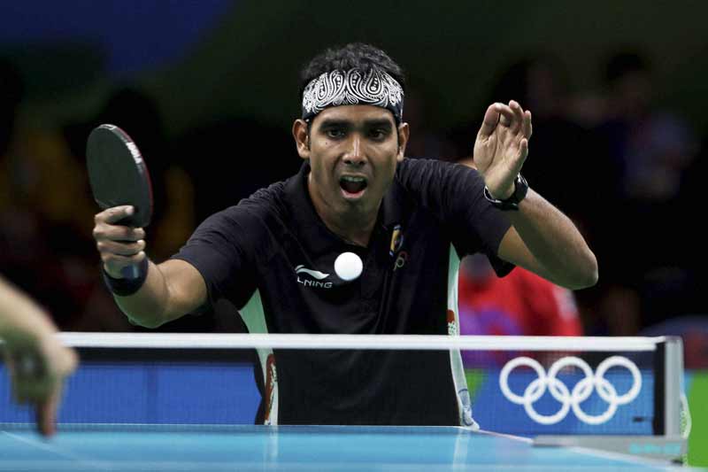 Achanta Sharath Kamal of India plays against Adrian Crisan of Romania during their table tennis match at the 2016 Summer Olympics in Rio de Janeiro, Brazil, Saturday. (AP/PTI)