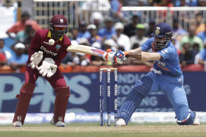 India's Lokesh Rahul, right, plays a shot as West Indies' Andre Fletcher watches the ball during the first Twenty20 international cricket match on Saturday. The exciting match saw two hundreds in each innings with Evin Lewis from West Indies and India's KL Rahul with an unbeatable score of 110 runs. (AP)