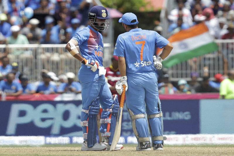 Presenting an excellent partnership, India's Lokesh Rahul, left, and MS Dhoni (7) in talks between overs during the first Twenty20 international cricket match against the West Indies. Despite pulling off one of the highest successful run chase, India lost its first T20 match to West Indies by 1 run in the last over. (AP)