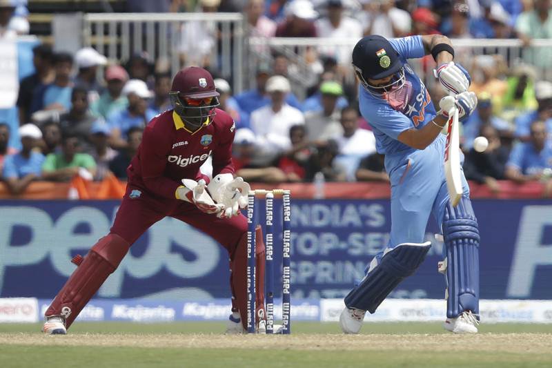 India's Virat Kohli, right, plays a shot as West Indies' Andre Fletcher looks on during the first Twenty20 international cricket match (AP)