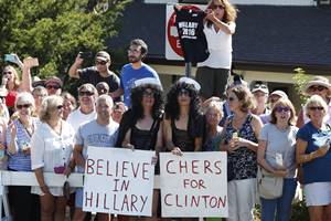 People dressed as Cher hold signs supporting Democratic presidential candidate Hillary Clinton near the entrance of Pilgrim Monument and Provincetown Museum in Provincetown (AP)