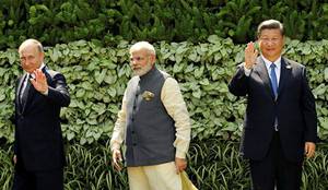 (L-R) Russian President Vladimir Putin, Indian Prime Minister Narendra Modi and Chinese President Xi Jinping leave after a group picture during BRICS Summit in Benaulim, in the western state of Goa. (Reuters) (L-R) Russian President Vladimir Putin, Indian Prime Minister Narendra Modi and Chinese President Xi Jinping leave after a group picture during BRICS Summit in Benaulim, in the western state of Goa. (Reuters)