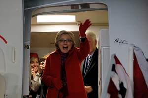 US Democratic presidential nominee Hillary Clinton waves from the door of her campaign plane to the crowd of campaign volunteers and workers who gathered to greet her at the airport in White Plains, New York. (Reuters)