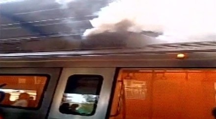 A stationary Delhi metro train started emitting heavy smoke from its upper chambers today. The incident took place at the Patel Chowk metro station where the metro was standing stationary. (Source: ANI)