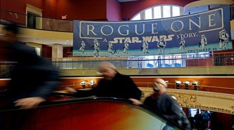 People ride an escalator under a Star Wars Rogue One poster at AMC Empire 25 on Christmas Day in Manhattan, New York City, U.S., December 25, 2016. REUTERS/Andrew Kelly