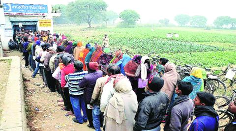 Villagers line up in front of a SBI branch to withdraw cash in Mirzapur. Villagers line up in front of a SBI branch to withdraw cash in Mirzapur.