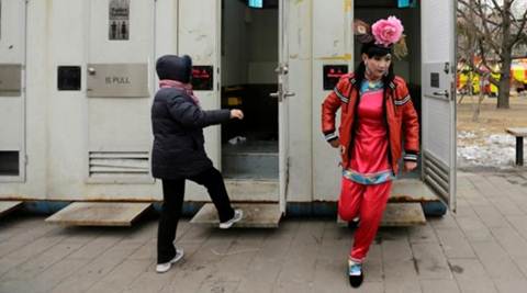 A male folk artist (R) dressed as a traditional Chinese woman walks out of a mobile toilet ahead of a performance at a Spring Festival Temple Fair on the fifth day of the Chinese Lunar New Year at Longtan Park in Beijing. (Reuters) A male folk artist (R) dressed as a traditional Chinese woman walks out of a mobile toilet ahead of a performance at a Spring Festival Temple Fair on the fifth day of the Chinese Lunar New Year at Longtan Park in Beijing. (Reuters)