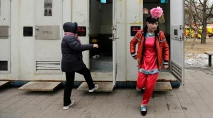 A male folk artist (R) dressed as a traditional Chinese woman walks out of a mobile toilet ahead of a performance at a Spring Festival Temple Fair on the fifth day of the Chinese Lunar New Year at Longtan Park in Beijing. (Reuters) A male folk artist (R) dressed as a traditional Chinese woman walks out of a mobile toilet ahead of a performance at a Spring Festival Temple Fair on the fifth day of the Chinese Lunar New Year at Longtan Park in Beijing. (Reuters)