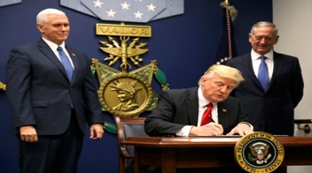 U.S. President Donald Trump (C) signs an Executive Order establising extreme vetting of people coming to the United States after attending a swearing-in ceremony for Defense Secretary James Mattis (R) with Vice President Mike Pence at the Pentagon in Washington, U.S., January 27, 2017. REUTERS/Carlos Barria