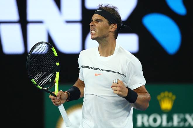 Spain's Rafael Nadal exults after playing a forehand to Switzerland's Roger Federer during the men's singles final at the Australian Open tennis championships in Melbourne, Australia. (AP Photo)