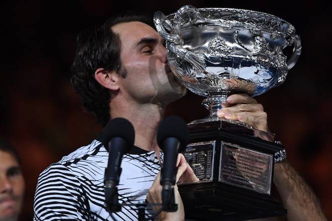 The trophy that matters. Roger Federer kisses the Australian Open trophy - his 5th and 18th overall. (Australian Open/Twitter)