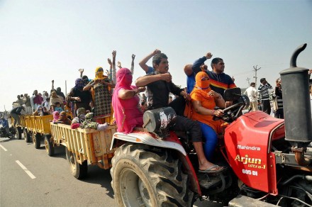 Rohtak: Jat community members arrive by tractors at Jassia village to take part in their agitation for reservation in Rohtak on Wednesday. PTI Photo (PTI2_8_2017_000287B)