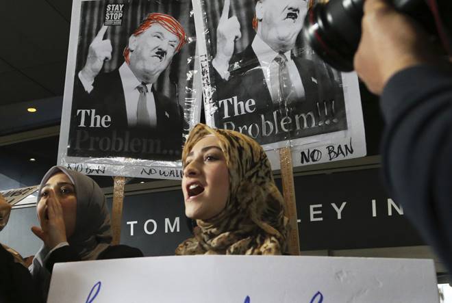 Women wearing traditional Muslim head coverings join demonstrators opposed to President Donald Trump's executive orders barring entry to the US by Muslims from seven countries at the Tom Bradley International Terminal at Los Angeles International Airport. (AP Photo)