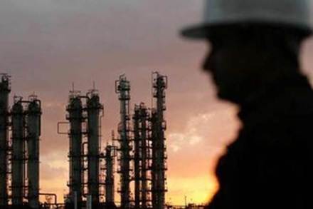 Oil futures supported by weaker dollar, but bloated supply still weighs