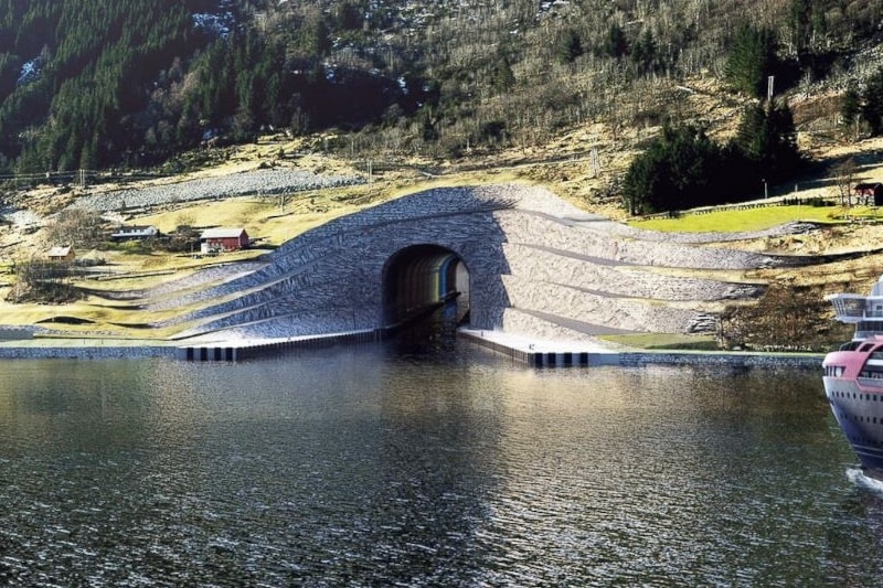 Norway to build world’s first ship tunnel through coast: Norway plans to build a 1,700-meter (5,610-feet) tunnel for ships – a world first – through a piece of rocky coast to allow vessels avoid a treacherous part of sea. Construction of the Stad Ship Tunnel, which will be 36 meters (118 feet) wide and 49 meters (162 feet) tall, is estimated to cost at least 2.7 billion kroner ($314 million) and is expected to open in 2023. (Pic: Artist impression)