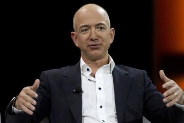 Bezos's Amazon.com Inc. and Indian rival Snapdeal, backed by Son, are spending billions of dollars to build e-commerce in India. (Reuters)