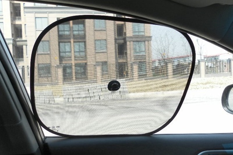 First thing that comes to mind, when talking about protection from heat in a car, is a sun shade. We've all seen them. They're sold on traffic signals, and are reasonably priced. But while, it sounds like an effective idea to stick one on every window and keep the sun out, there are rules regarding their usage. You must not use them on the front windows while driving as they will block your view. However, if the car is parked, it is sensible to stick them on windows to prevent heating. You can either buy stick on sun shades or foldable ones. (Image: aliexpress)
